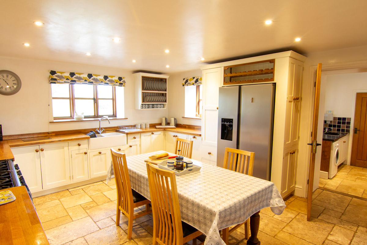 Kitchen: “Modern kitchen at Colstey Farmhouse equipped with state-of-the-art appliances and a spacious dining area.”