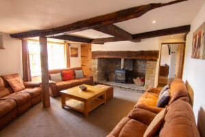 Living Room: “Cozy living room at Colstey Farmhouse featuring comfortable seating, a warm fireplace, and elegant decor.”