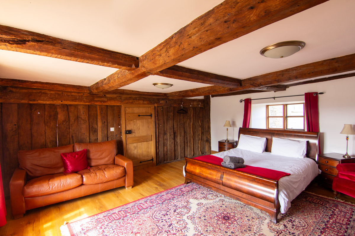 Bedroom: “Inviting bedroom at Colstey Farmhouse with a plush bed, soft lighting, and serene ambiance for a restful stay.”
