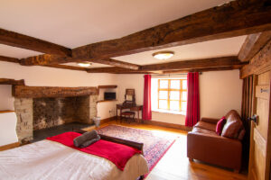 Bedroom: “Inviting bedroom at Colstey Farmhouse with a plush bed, soft lighting, and serene ambiance for a restful stay.”